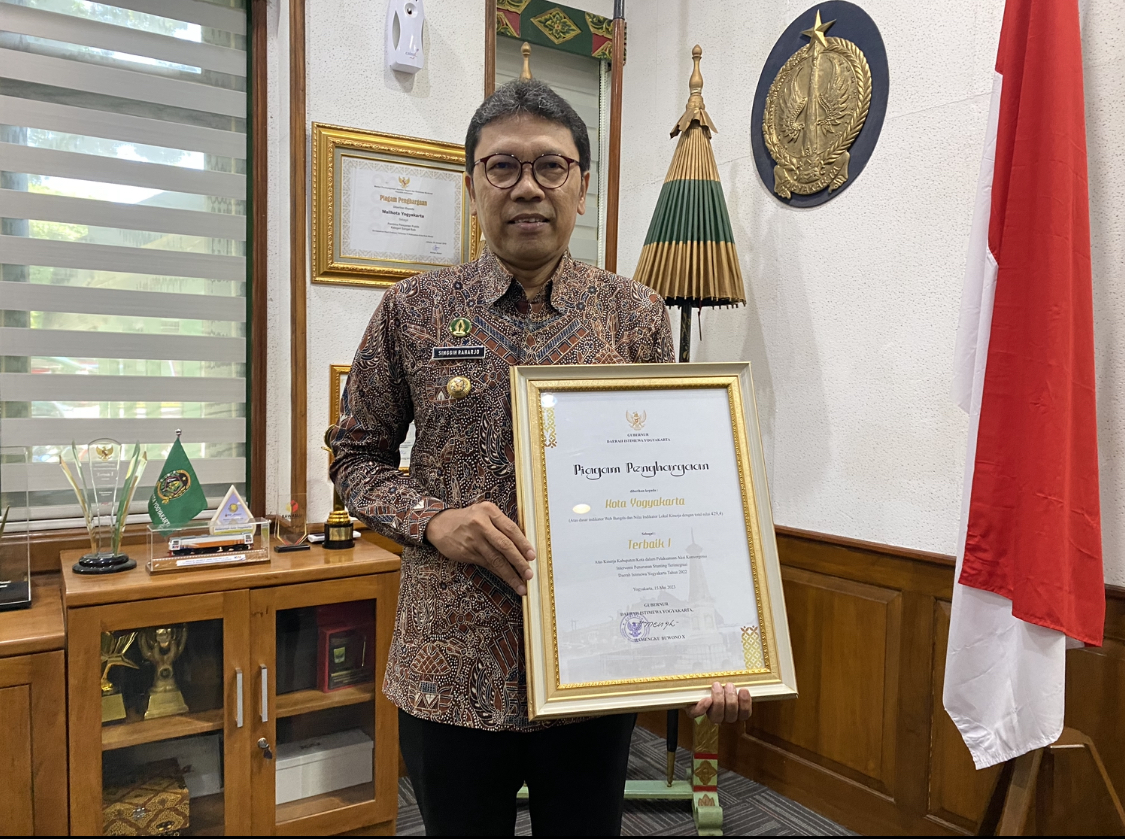 KOLABORASI: Penjabat Wali Kota Jogja Singgih Raharjo memamerkan piagam penghargaan Aksi Konvergensi Intervensi Penurunan Stunting Terintegrasi di DIJ Tahun 2022.
