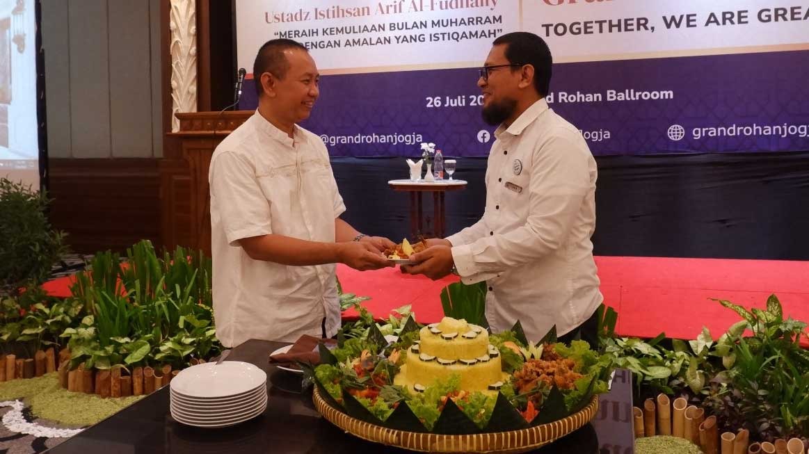 ULANG TAHUN: General Manager Grand Rohan Jogja Asmoro Handriyanto memberikan potongan tumpeng kepada Direktur Utama Grand Rohan Jogja drh H Agung Tri Haryanto, MM. (Istimewa)