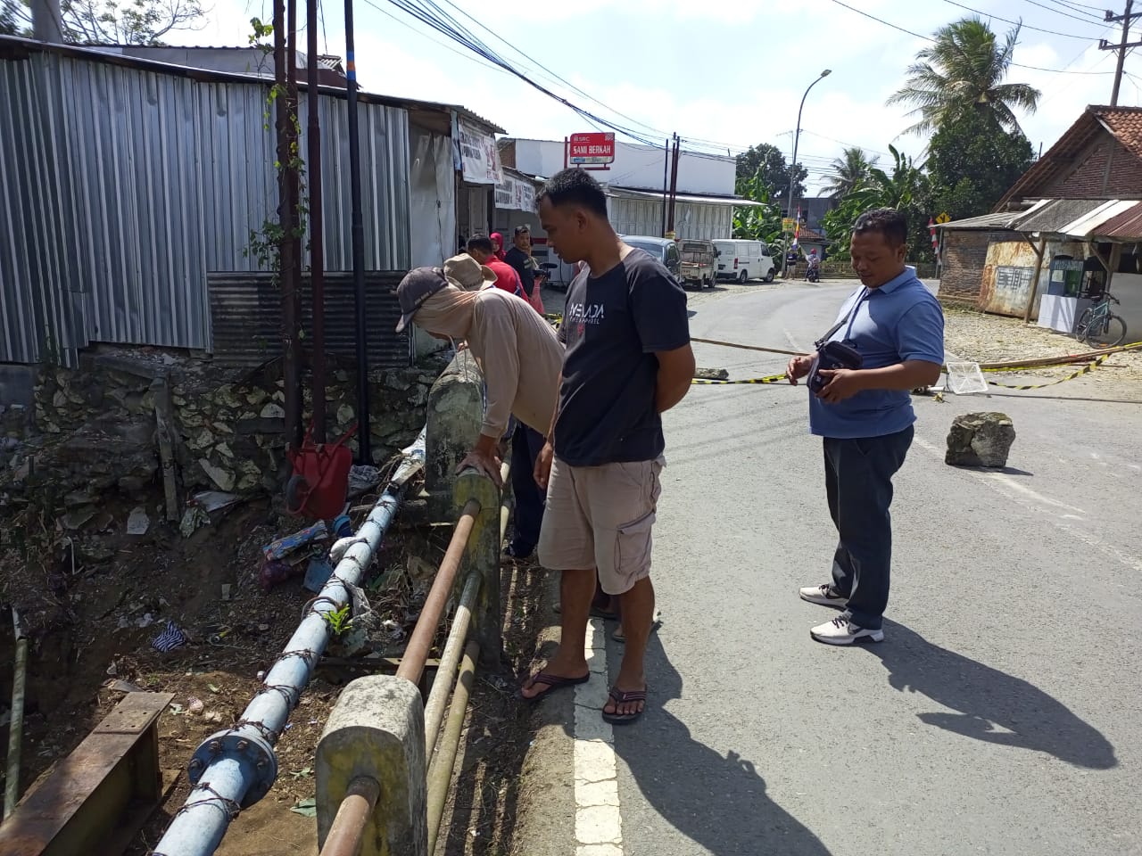 KHAWATIR : Warga melihat kondisi Jembatan Mergosono pasca ambles sekitar 30 cm pada bagian fondasi. (M HAFIED/RADAR KEBUMEN)