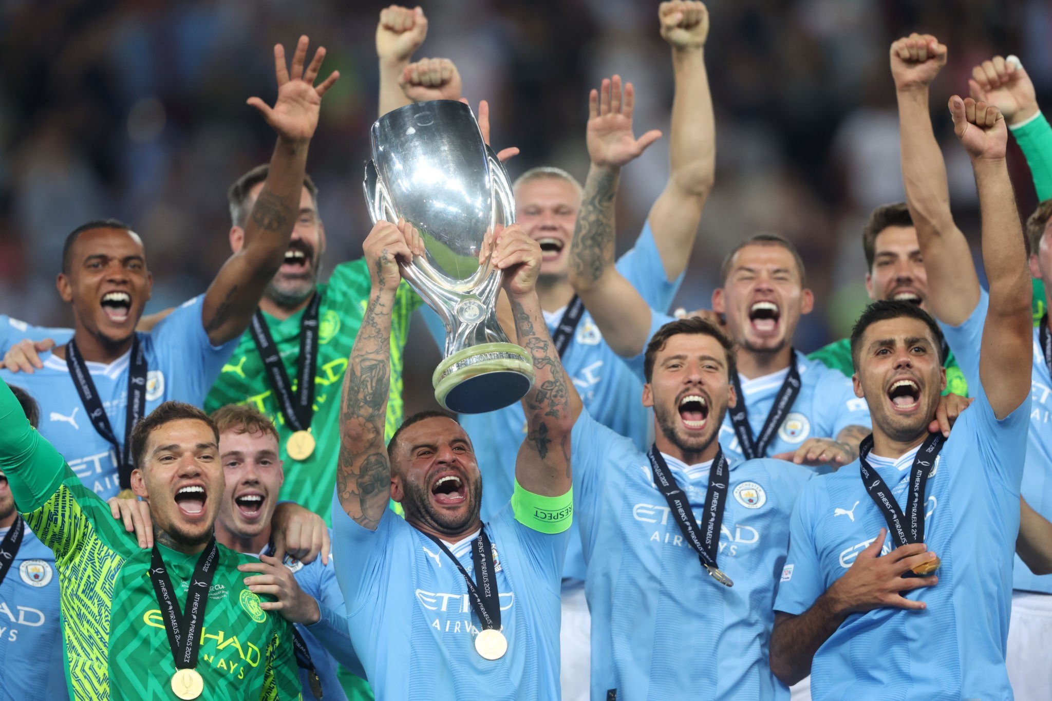 SANG JUARA: Kapten Manchester City Kyle Walker mengangkat piala UEFA Supercup setelah mengalahkan Sevilla dalam adu penalti