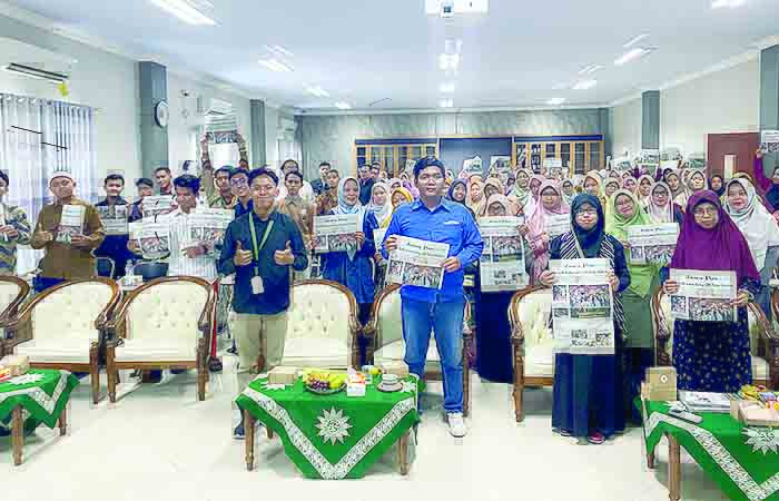 LITERASI: Ratusan kader Muhammadiyah Kebumen menujukkan koran Jawa Pos sebagai bahan ajar pelatihan jurnalistik, Minggu (8/10).