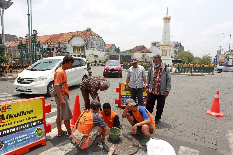 PASTIKAN: Petugas mengecek limbah di sebelah utara Tugu Pal Putih Jogja. (Guntur Aga Tirtana/Radar Jogja)