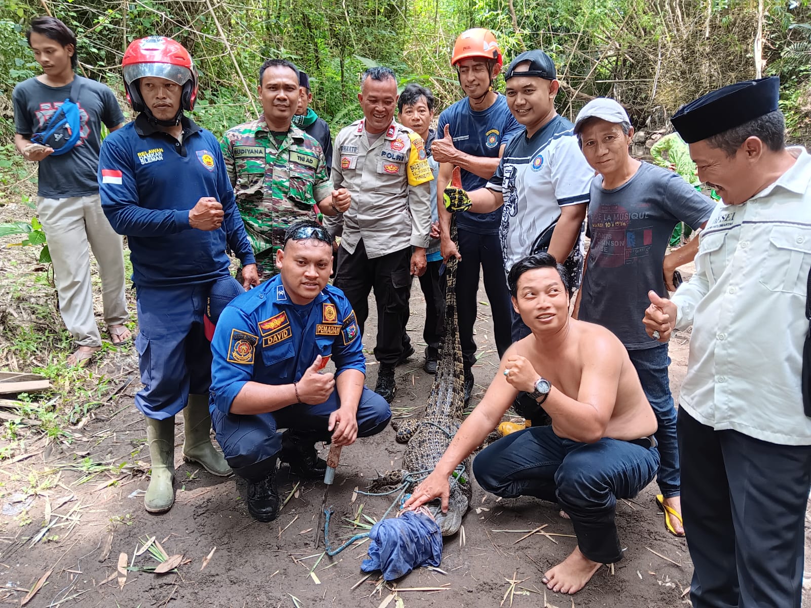 CEPAT: Sejumlah petugas saat melakukan evakuasi terhadap seekor buaya liar di Sungai Tepus, Padukuhan Jetak, Selomartani, Kalasan, pada Jumat (26/1).