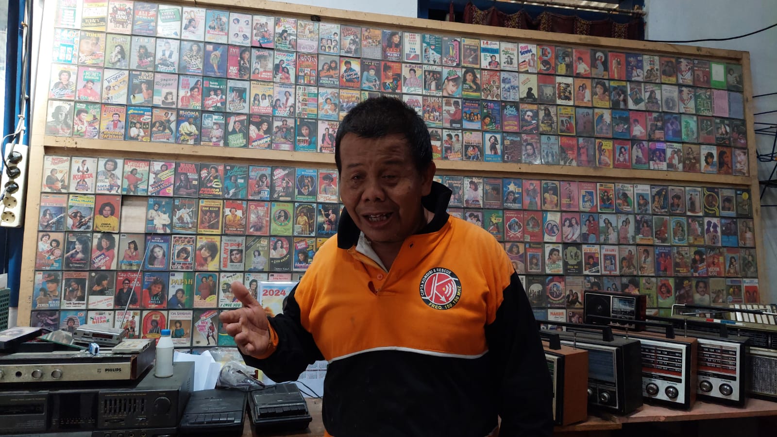 BAHAGIA: Mbah Wondo dengan koleksi kaset miliknya yang dikumpulkan sejak muda.