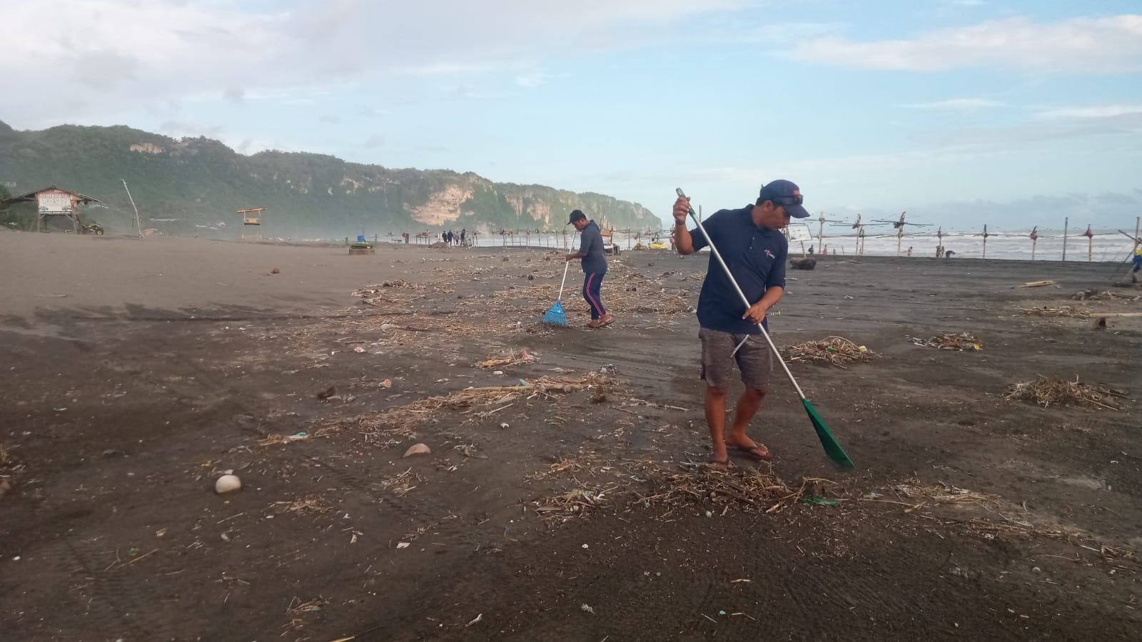RERESIK: Petugas membersihkan sampah yang berada di kawasan Pantai Parangtritis Bantul, Minggu (14/4).(Dokumentasi Dinas Pariwisata Bantul)