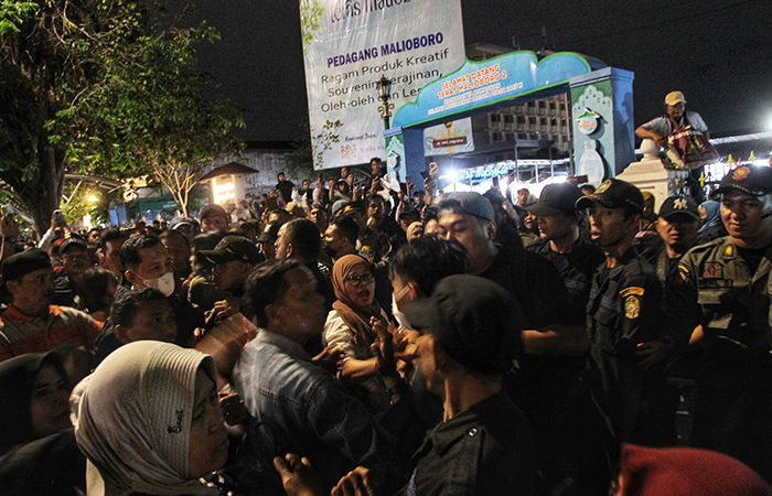 DIHADANG PETUGAS: Pedagang Teras Malioboro (TM) 2 dihadang Satpol PP saat hendak keluar untuk bisa berjualan di selasar Maliboro, Minggu (18/8) malam.