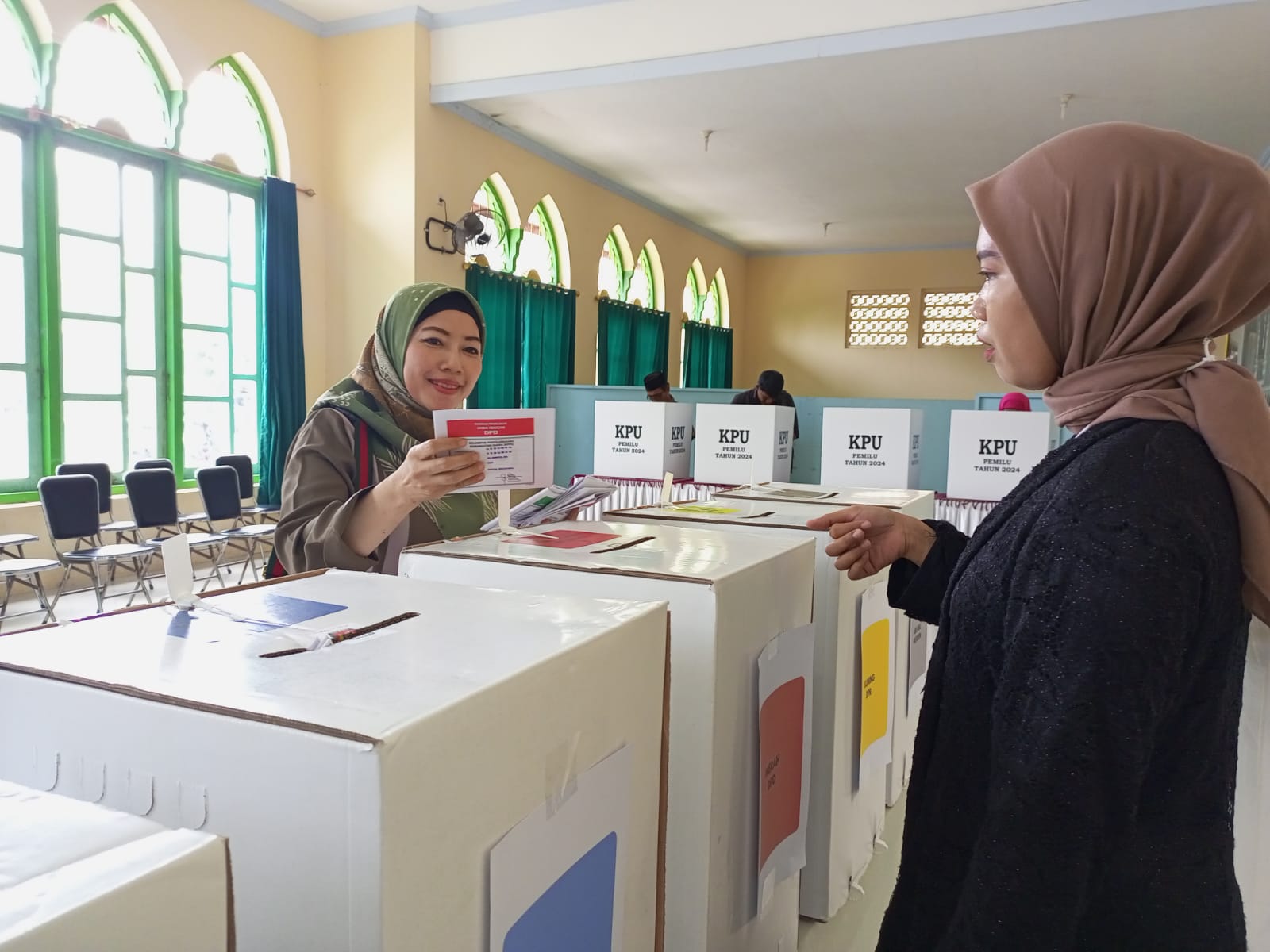 BADAN ADHOC KPU : Petugas KPPS di Kelurahan Bumirejo melayani pemilih saat coblosan Pemilu 2024.
