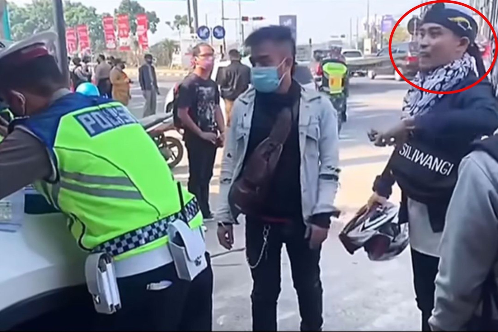 Pria yang berpura-pura kesurupan (dilingkari merah) saat ditilang polisi.