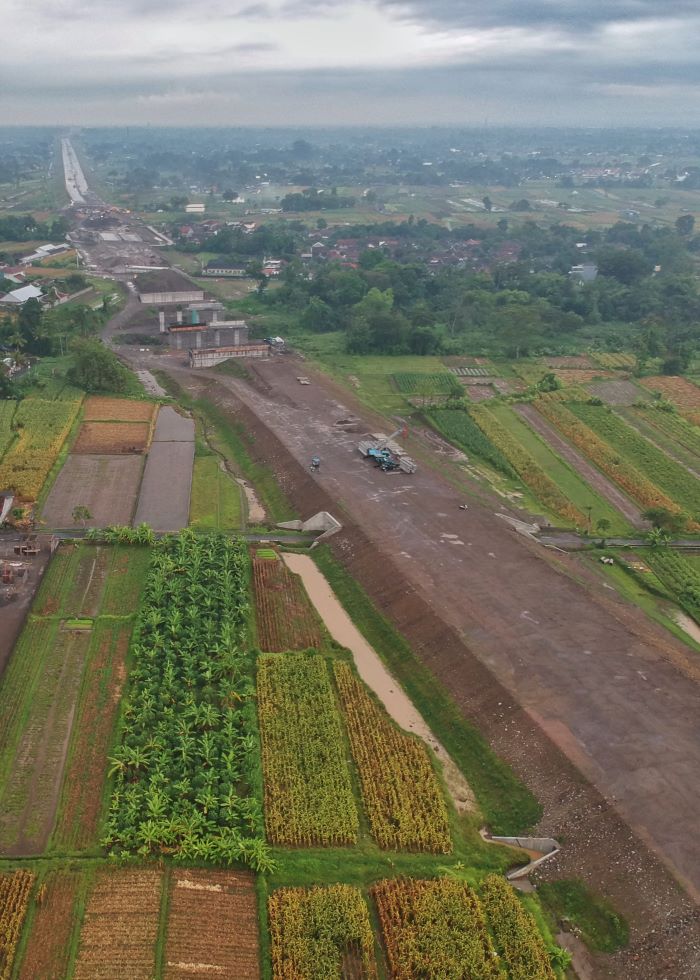 SEPARO JALAN: Foto udara progres pembangunan jalan Tol Jogja-Solo terlihat dari kawasan Selomartani, Kalasan, Sleman Selasa (19/11/2024).