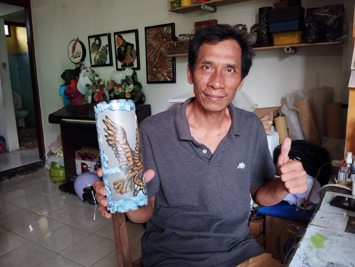 MERAMBAH MANCANEGARA: Alip Sudarmanto, 52, saat mengerjakan kerajinan lampu dari paralon di bengkel produksinya, Kelurahan Pangenrejo, Purworejo, Sabtu (7/12/2024).