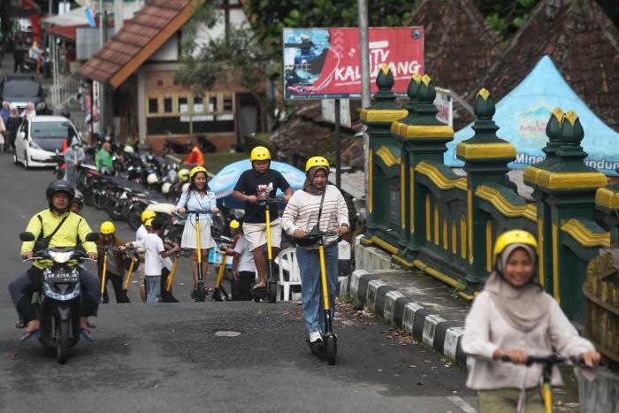 Wisatawan saat menaiki skuter listrik di kawasan Kaliurang, Sleman Minggu (29/12/2024)