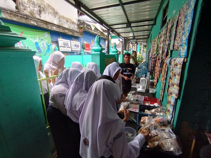 TETAP BUKA: Siswa SMPN 1 Sentolo saat membeli makanan ringan di kantin sekolah. Namun, omzet kantin sekolah turun karena adanya program MBG.