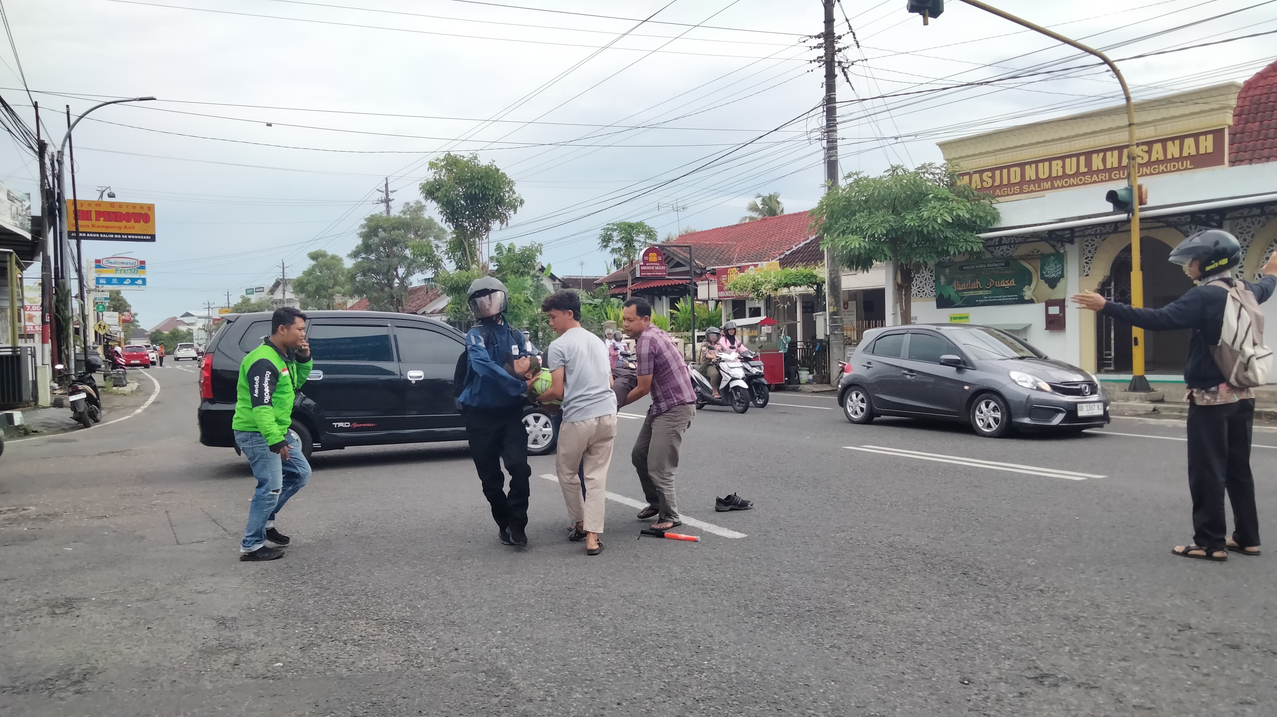 Korban digotong oleh warga usai  tertabrak mobil di Simpang Tiga Pendowo KH. Agus Salim, Wonosari, Gunungkidul, Kamis (23/1) sore.