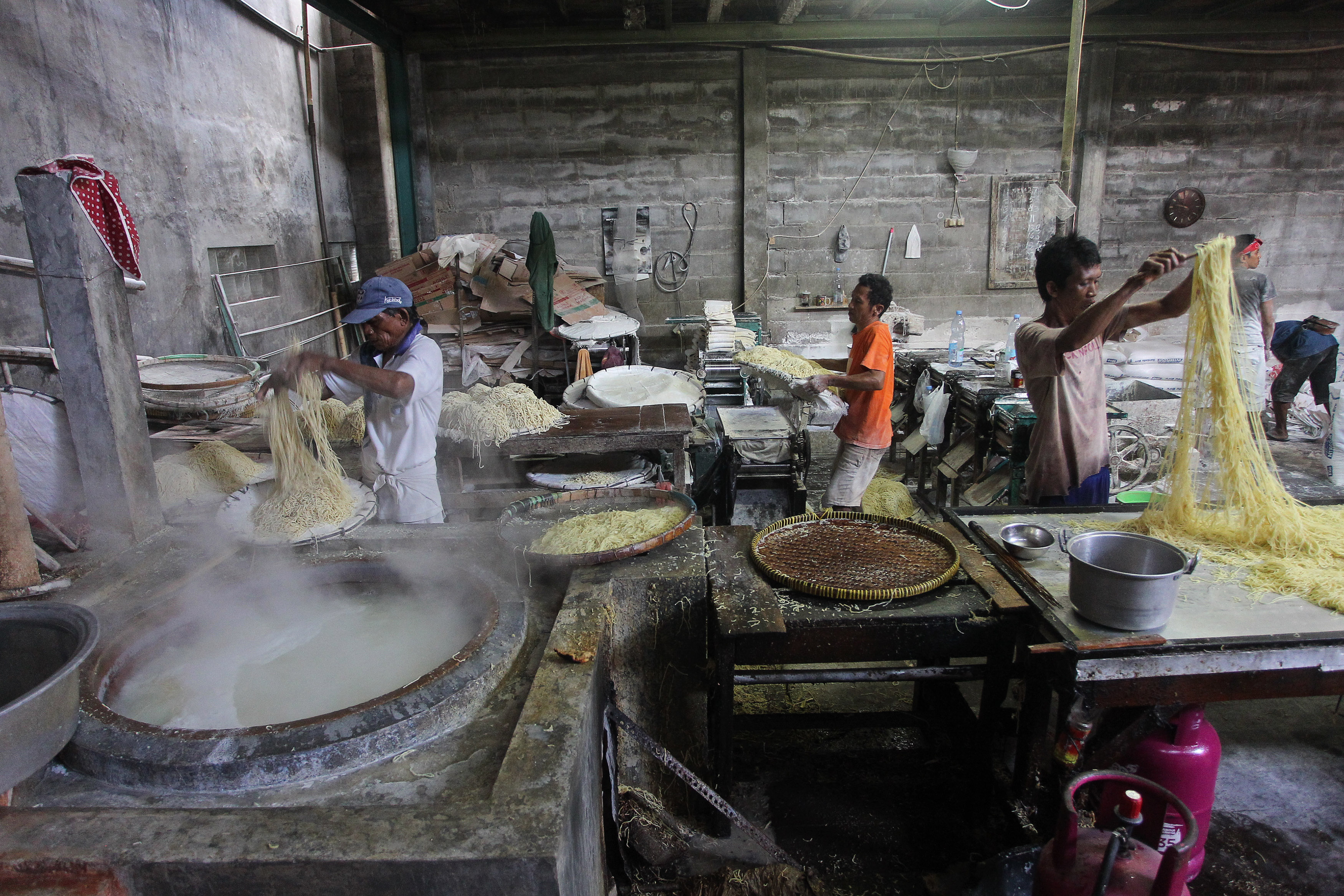 LEGEND: Pekerja sedang melakukan proses produksi mi basah di Ketandan, Jogja kemarin (28/1). Tahun Baru Imlek ini tidak berpengaruh signifikan terhadap penjualan.