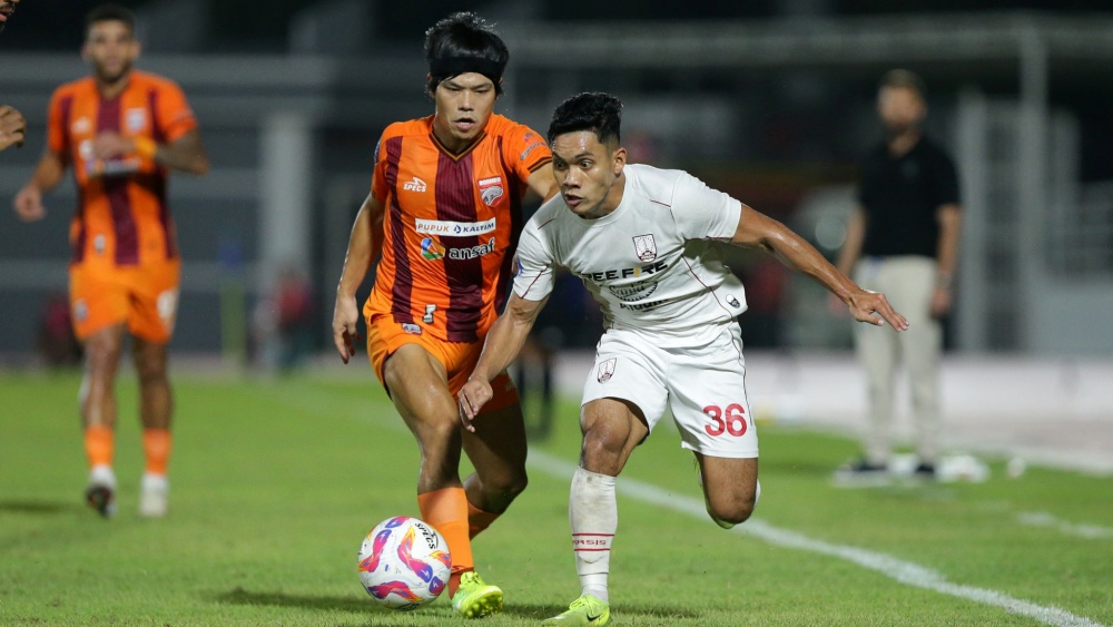 Pemain Persis Solo, Althaf Alrizky (putih) coba menguasai bola dari rebutan pemain Borneo FC (LIB)