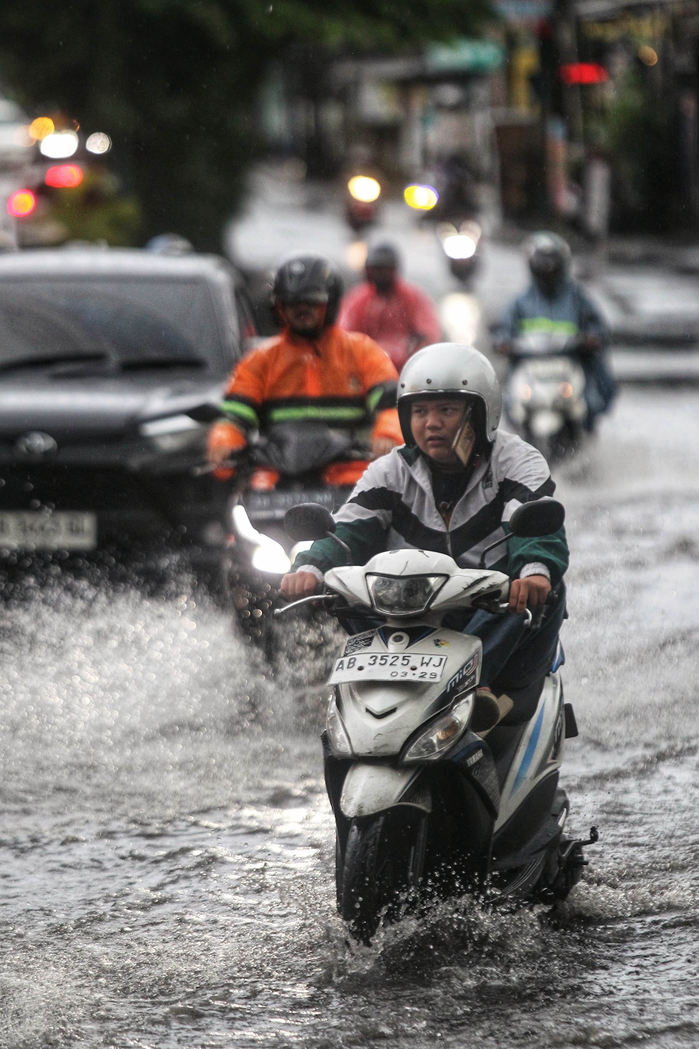 Pengendara kendaraan bermotor menerjang genangan air hujan di jembatan yang melintang di atas Sungai Winongo, Jalan Kyai Mojo, Kota Jogja, Selasa (11/3). Titik rawan genangan air hujan di jalanan wila