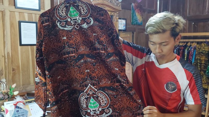 HASIL: Bayu Permadi menunjukkan batik karya ciptanya.&nbsp;