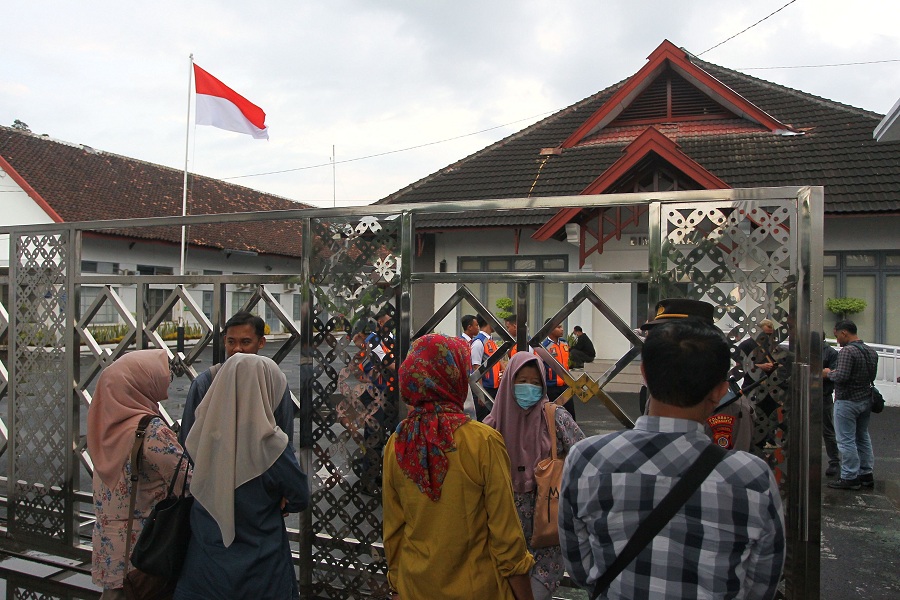 Sejumlah warga Tegal Lempuyangan, Bausasran, Danurejan, yang terdampak rencana revitalisasi Stasiun Lempuyangan berada di depan Kantor Daop 6 Yogyakarta usai audiensi tertutup, Selasa (17/6/2025).