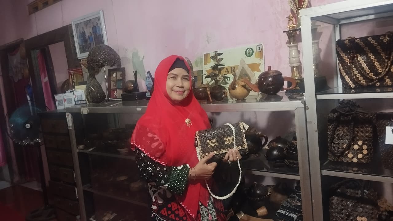 KREATIF: Harianti sedang memegang produk tas yang dibuat dari Limbah batok kelapa Kamis (21/8)