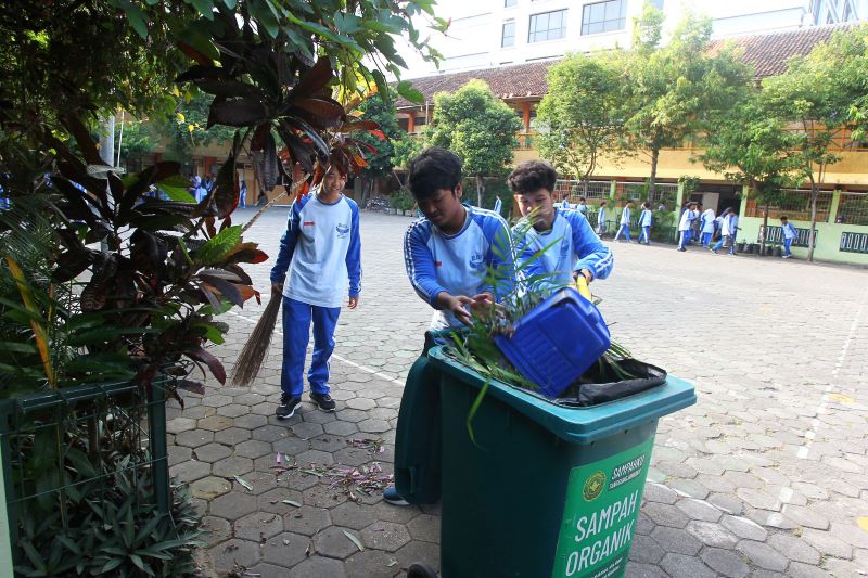 GOTONG-ROYONG: Sejumlah pelajar SMPN 8 Jogja membersihkan lingkungan sekolah Jumat (19/9). Tahun ini, tema kebersihan lingkungan juga diangkat untuk memperingati HUT ke-269 Kota Jogja