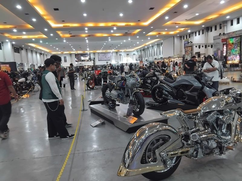 Para pengunjung menikmati pameran otomotif motor hasil modifikasi builder lokal di acara Kostomfest 2025 yang berlangsung di JEC, Sabtu (4/10/2025).