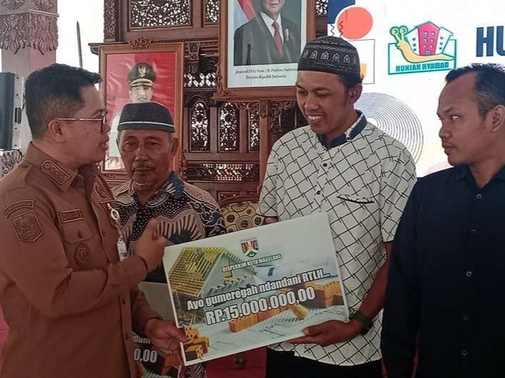 SIMBOLIS: Wali Kota Magelang saat menyerahkan bantuan program rehabilitasi RTLH, Selasa (21/10).