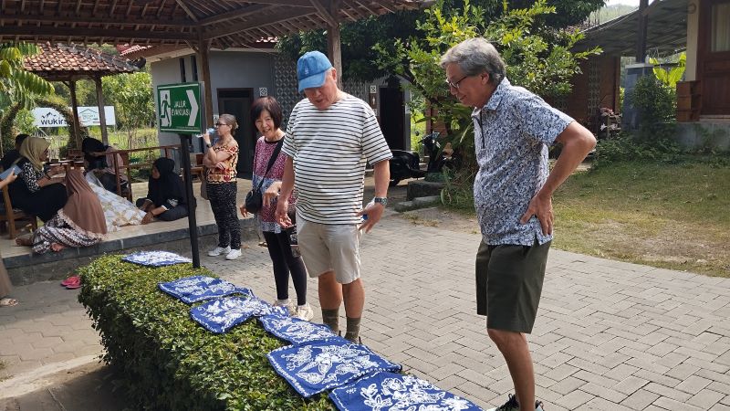 FOKUS: Wisatawan mancanegara saat menjemur batik yang baru dibuatnya di Kampung Batik Giriloyo.