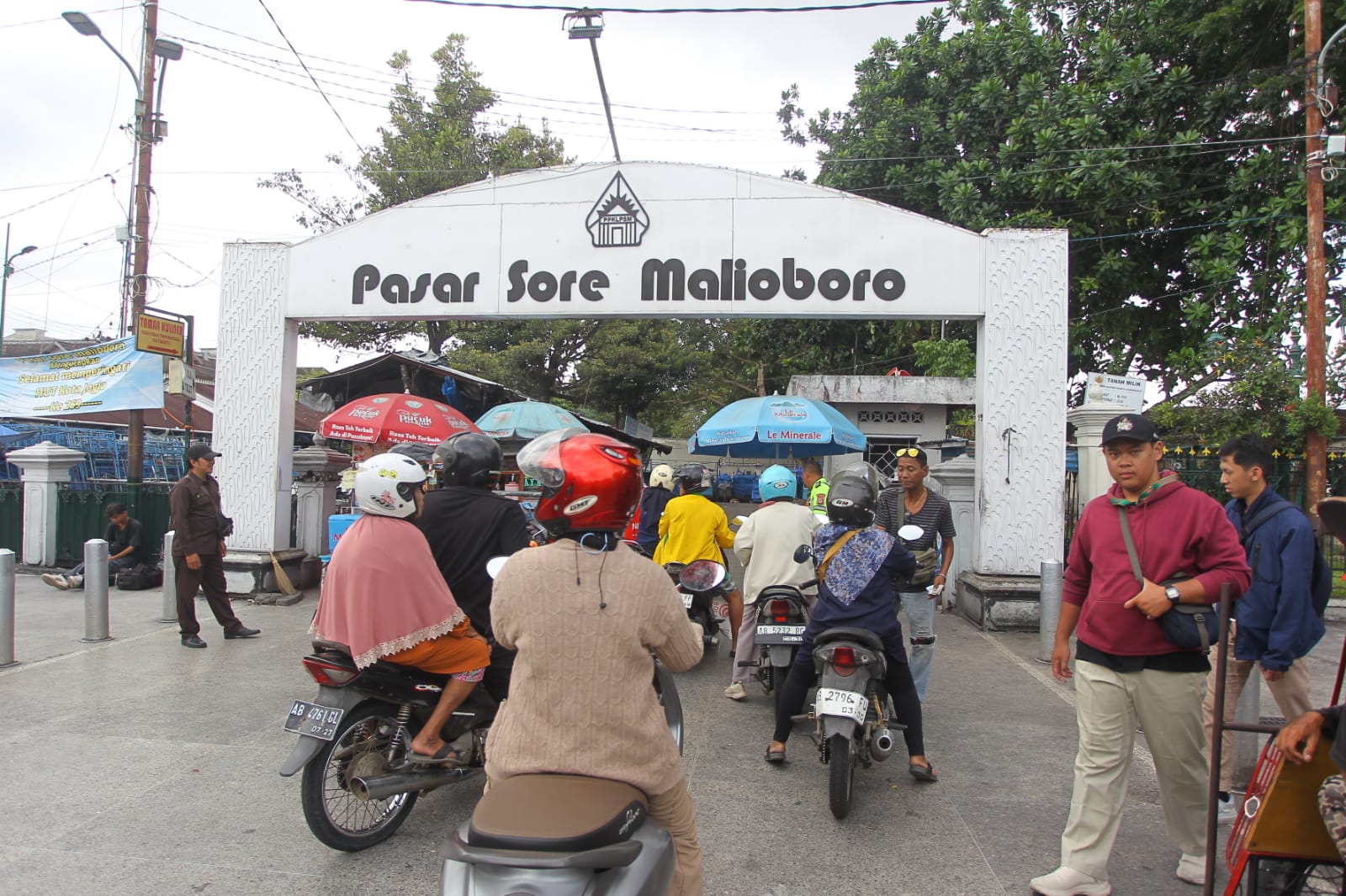 Pengendara sepeda motor membayar ke juru parkir agar dapat melintasi area Pasar Sore Malioboro untuk menuju Jalan Pabringan sisi selatan Pasar Beringharjo, Kota Jogja, Senin (1/12).