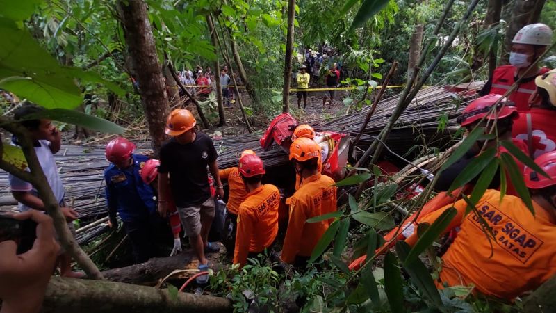 EVAKUASI: Personel Basarnas mencoba melepas korban dari badan truk yang ringsek.&nbsp;