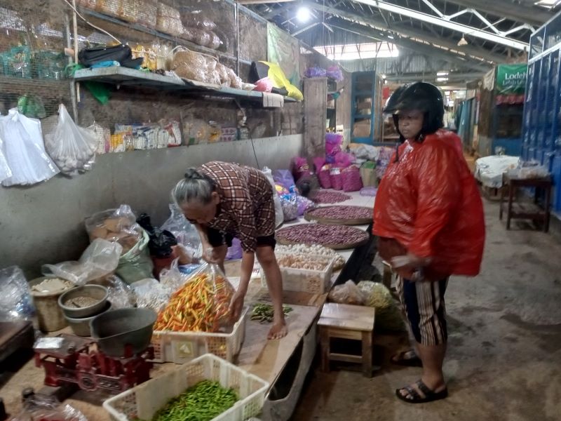 JUAL BELI: Pedagang sayur di Pasar Playen saat melayani pembeli Senin (2/2).