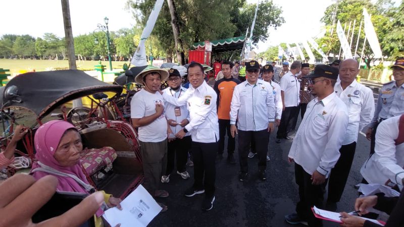 SERAH TERIMA SIMBOLIS: Wakil Bupati Kulon Progo memberikan bantuan uang tunai ke tukang becak.&nbsp;  