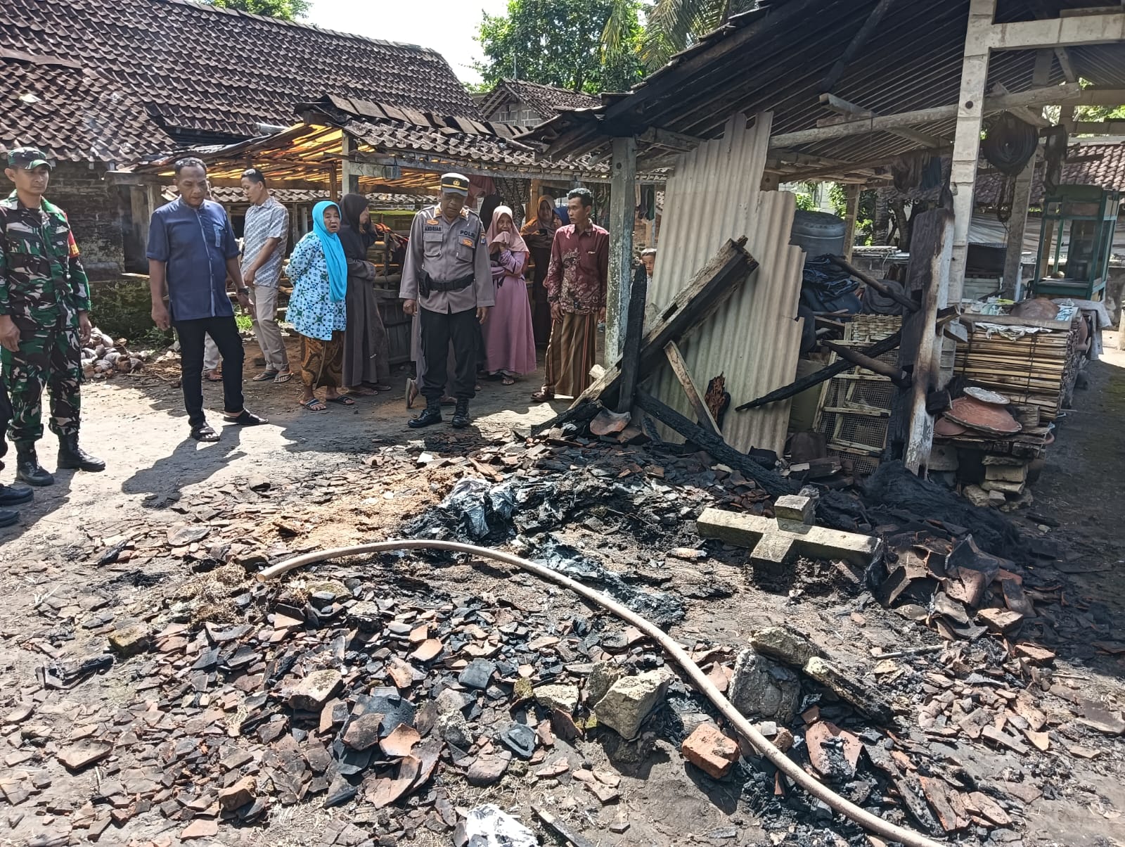 Personel kepolisian dan warga setempat mendatangi TKP kebakaran. 