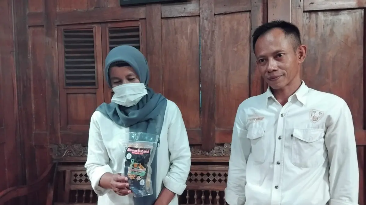 Pencipta Wedang Ereng-ereng Jemi Kanas dan istrinya saat meracik Wedang Ererng-ereng. (Rizky Wahyu/Radar Jogja)
