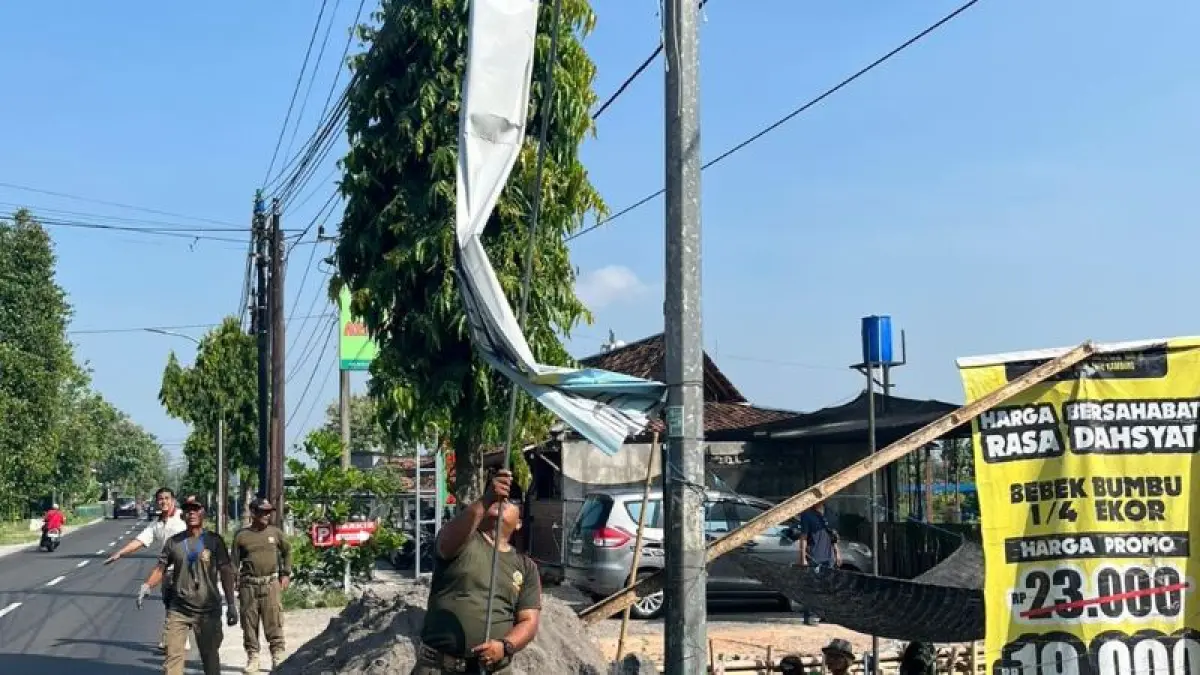 ILEGAL: Petugas Satpol PP Bantul sedang melepas spanduk yang melanggar aturan Rabu (13/5). (Dokumentasi Satpol PP Bantul)