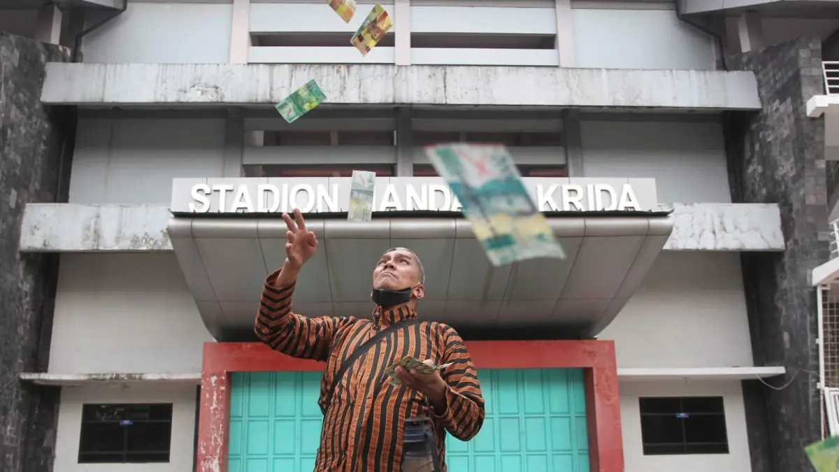 Aktivis Jogja Corruption Watch (JCW) Baharuddin Kamba menggelar aksi tetrikal di kawasan Stadion Mandala Krida, Kota Jogja, Selasa (19/5) siang - GUNTUR AGA-RADAR JOGJA