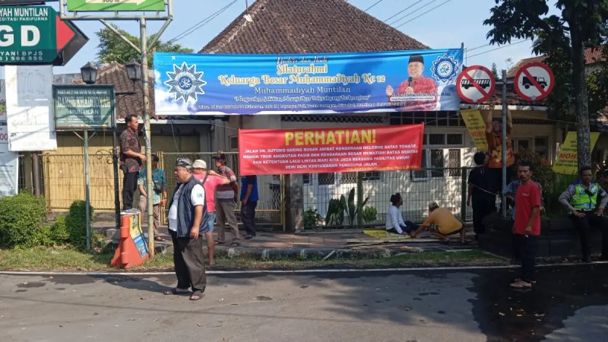 ANTISIPASI: Warga memasang sejumlah banner yang melarang kendaraan bertonase besar melintasi Jalan Dr Sutopo, Muntilan. (NAILA&nbsp;NIHAYAH/RADAR JOGJA)