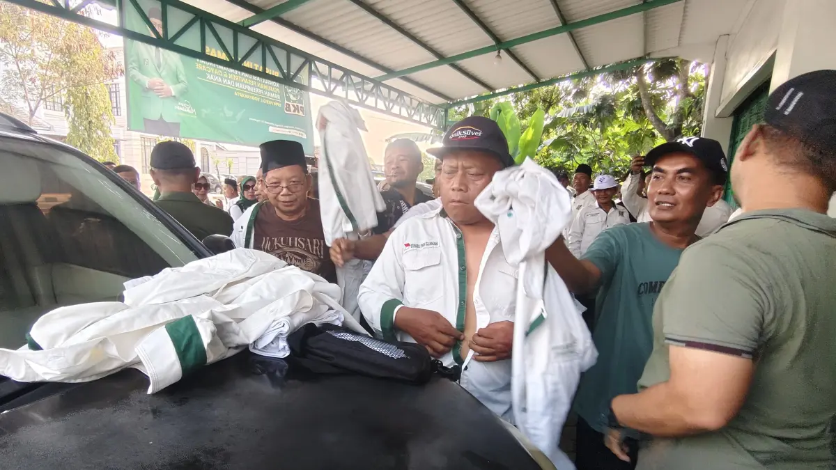 PAMIT : Puluhan kader yang tergabung dalam Forum Komunikasi Dewan Pimpinan Anak Cabang (DPAC) PKB se-Kabupaten Sleman melepaskan dan mengembalikan seragam kebesaran partai di Kantor DPW PKB DIY Jumat sore (26/6/2026). Dalam aksinya mereka menolak keras keputusan DPP PKB terkait penunjukan ketua baru DPC PKB Sleman. (Foto: Nanang Febriyanto/Radar Jogja) 