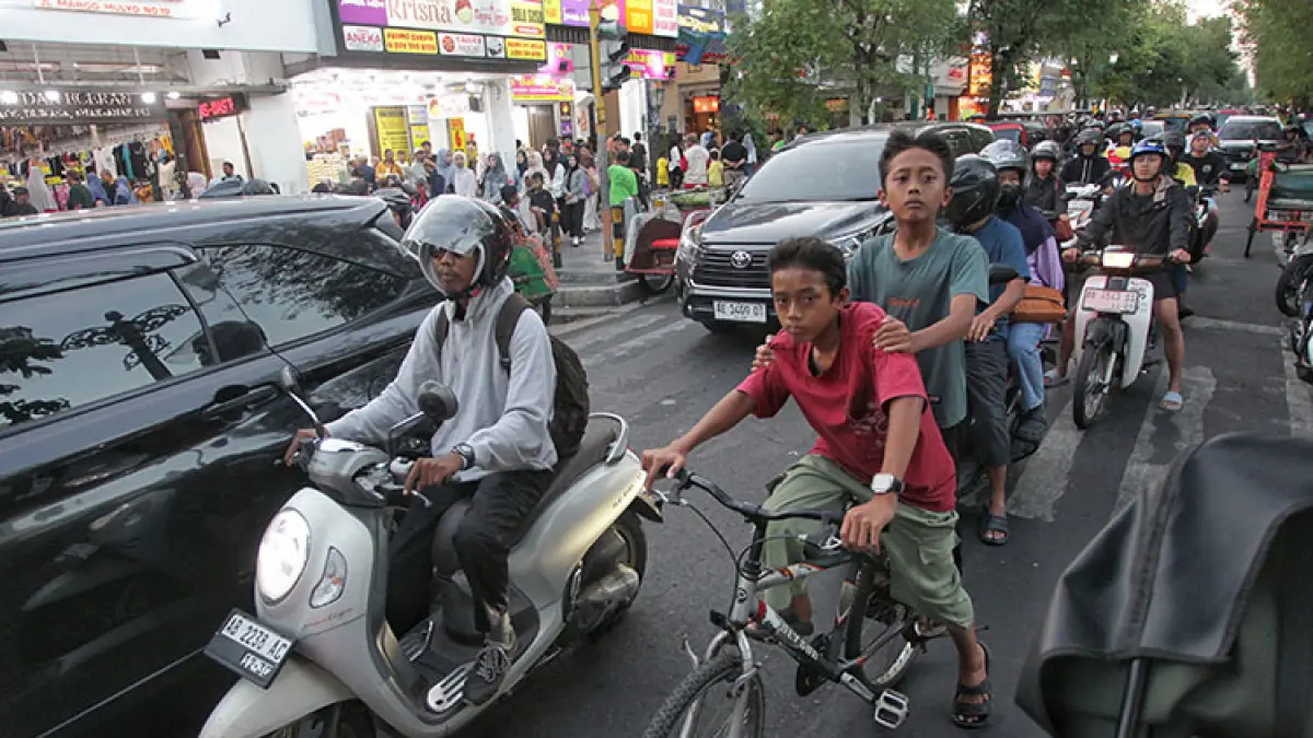 TUMPLEK BLEK: Pesepeda bercampur dengan kendaraan bermotor saat melintas di kawasan Malioboro, Jogja, Kamis (2/7/2026). Padatnya Malioboro menjadikan pesepeda tidak prioritas. (Foto: Guntur Aga Tirtana/Radar Jogja)