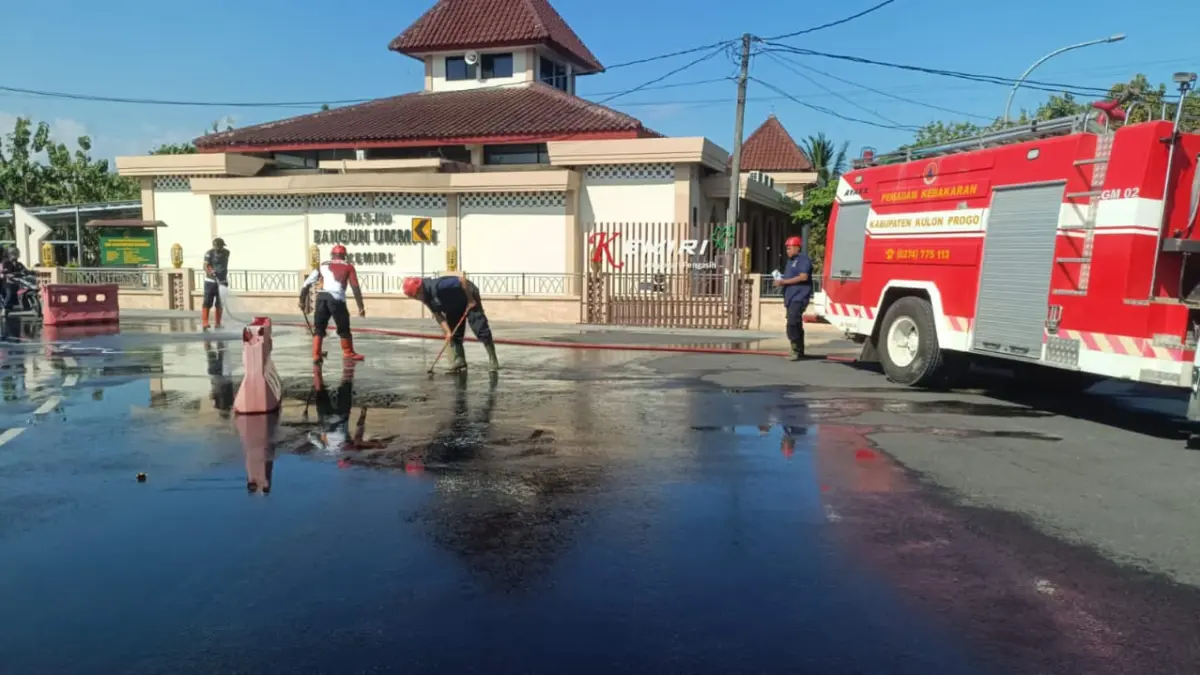 SIKAT SAMPAI BERSIH: Personel Damkarmat Kulon Progo membersihkan sisa tumpahan solar dengan air sabun dan disikat. (Dokumentasi BPBD Kulon Progo)