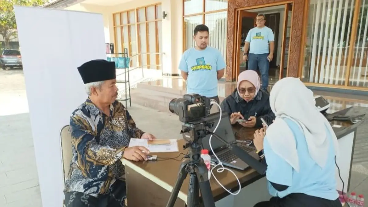 JEMPUT BOLA: Masyarakat menikmati layanan pembuatan paspor di halaman gedung DPRD Kebumen Minggu (26/7). ( M Hafied/Radar Jogja)