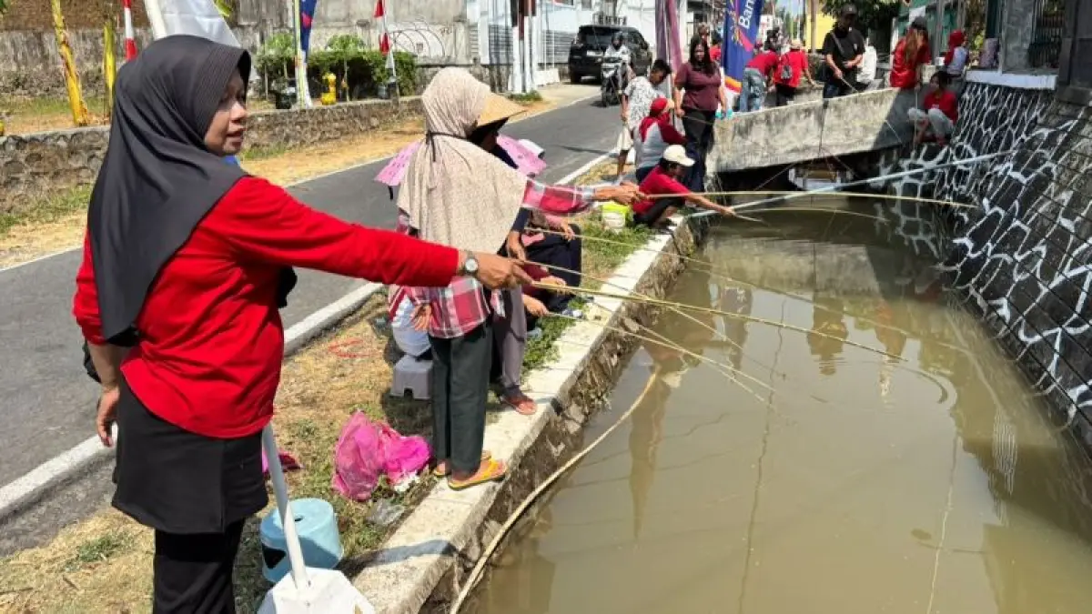 KOMPAK: Warga RT 4 Dusun Prajenan, Mertoyudan mengikuti lomba memancing di sungai kecil Minggu (16/8). (NAILA NIHAYAH/RADAR JOGJA)