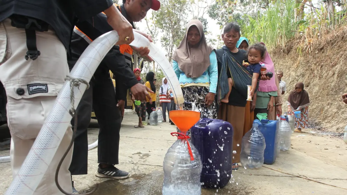 Warga Padukuhan Banaran, Pendoworejo, Girimulyo, Kulon Progo, mengantre untuk mendapatkan bantuan air bersih di tengah kemarau panjang, Rabu (19/8). (Guntur Aga/Radar Jogja)