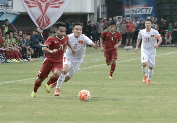 PERTAHANKAN BOLA: Andik Vermansyah sedang menggiring bola dibayangi pemain Vietnam. Timnas Indonesia berhasil menahan Vietnam 2-2 dalam laga persahabatan di Maguwo International Stadium, kemarin (9/10). (Foto: SETIAKY A. KUSUMA/RADAR JOGJA )