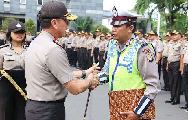 Kapolda Metro Jaya Irjen M Iriawan memberi penghargaan ke Aiptu Sutisna dalam apel pagi di Mapolda Metro Jaya, Rabu (14/12). Aiptu Sutisna merupakan anggota Ditlantas Polda Metro Jaya yang menjadi korban amarah seorang ibu yang menolak ditilang di Jalan J