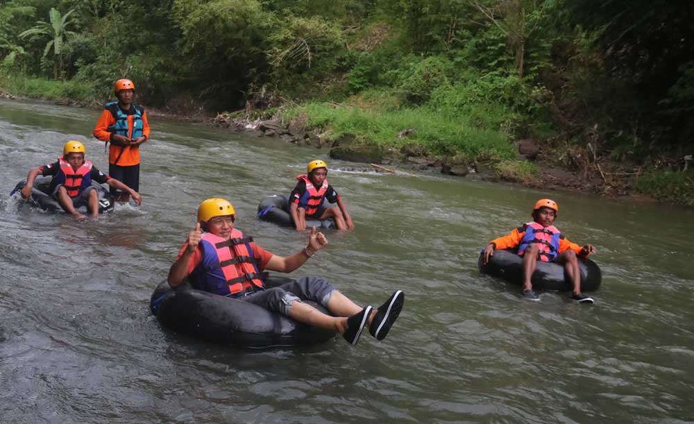 SERU: Sri Purnomo menjajal Geo Tubing Lava Bantal di Kalitirto, Berbah, Sleman kemarin.(Foto:SETIYAKI/Radar Jogja)