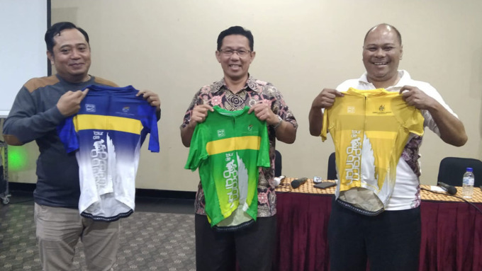 SIAP DIGELAR: Ketua Pelaksana Tour de Prambanan (TdP) 2022 Syukron Arif Muttaqin (kiri), Agung Tris Sasongko, dan Kus Endarto menunjukkan jersey yang akan digunakan para peserta TdP 2022.(NANANG FEBRIANTO/RADAR JOGJA)