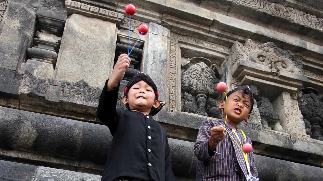 PACU MOTORIK: Dua anak tengah bermain lato-lato. Meski meningkatkan daya kreativitas anak, mainan lato-lato dilarang dibawa ke sekolah. Hal itu dikarenakan efek negatif lato-lato yang membutuhkan pengawasan dalam memainkannya. (GUNTUR AGA/RADAR JOGJA)