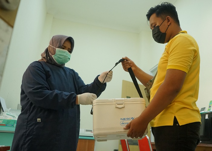 Driver Maxim menyerahkan cooler box berisi sampel darah kepada petugas loket laboratorium RSUD Campurdarat dr Karneni, jumat (23/6/2023) pagi.