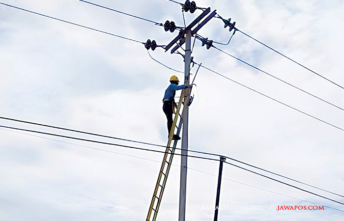 Ilustrasi seorang petugas PLN saat melakukan perbaikan kabel listrik.