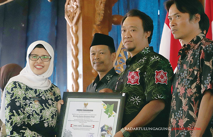 TERTIB PAJAK: Bupati Rini Syarifah menyerahkan penghargaan kepada kepala desa yang telah mendukung pembayaran pajak tepat waktu.